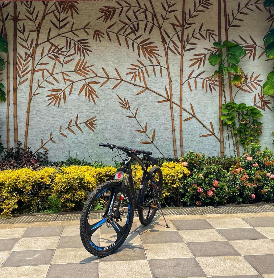 Radisson Blu Plaza Resort & Convention Centre Karjat Exterior photo A bicycle parked in front of a wall with a bamboo design